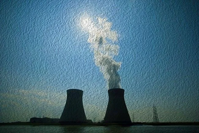 Two large cooling towers emit white steam into a blue sky, with the sun partially visible above them; a power line is seen in the background.