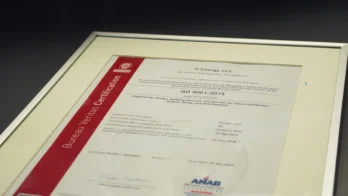 A framed ISO 9001:2015 certificate from Bureau Veritas Certification awarded to X-Energy LLC for quality management in engineering and design services.