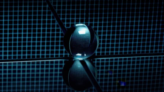 A glass sphere sits on a reflective surface with a blue grid pattern background, creating a symmetrical reflection beneath it.
