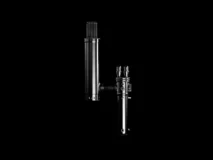 A metallic cylindrical object with various knobs and attachments against a solid black background.