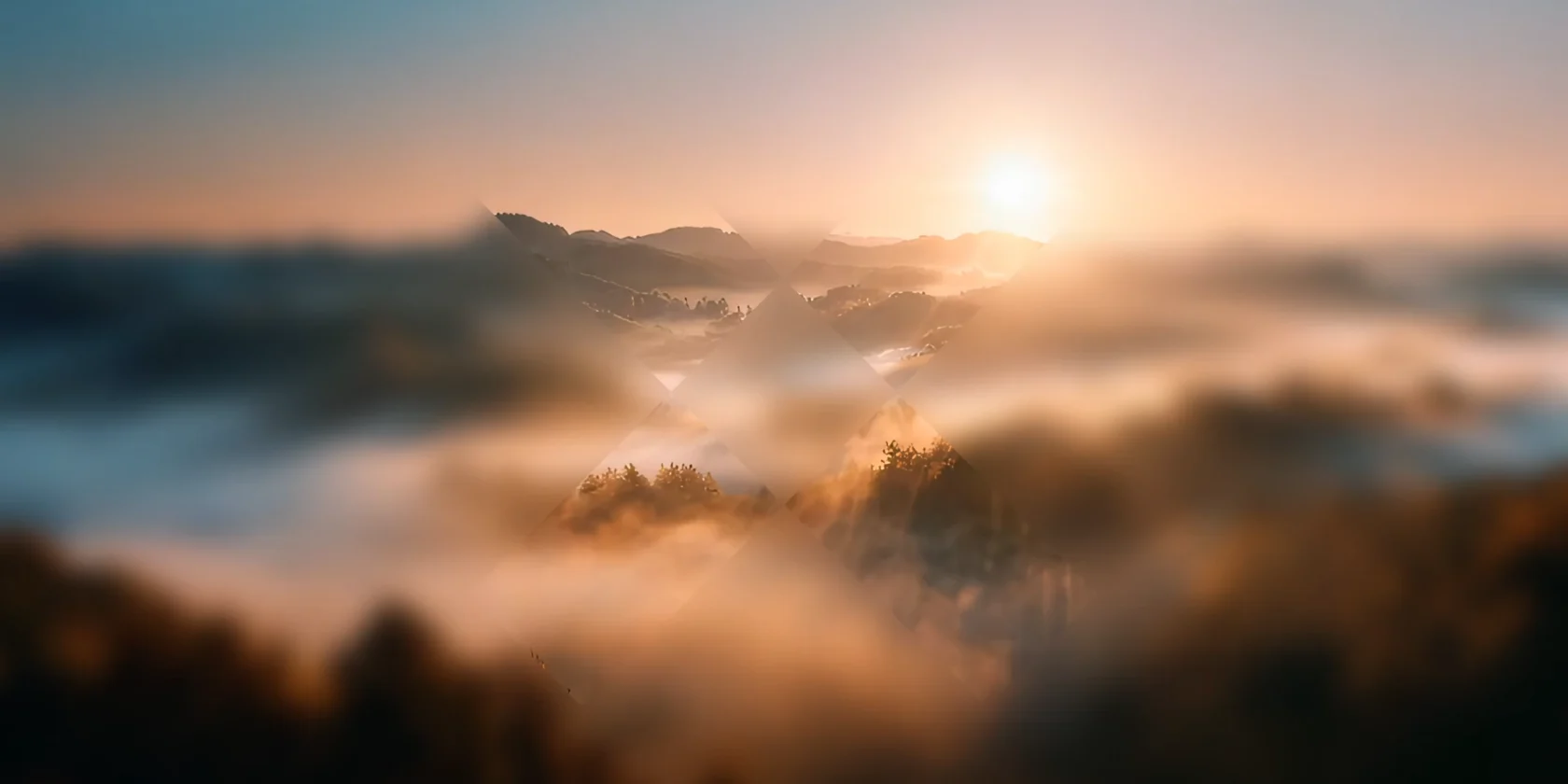 Sunrise over a misty mountain valley with warm golden light, partially revealed through a geometric X-shaped overlay.