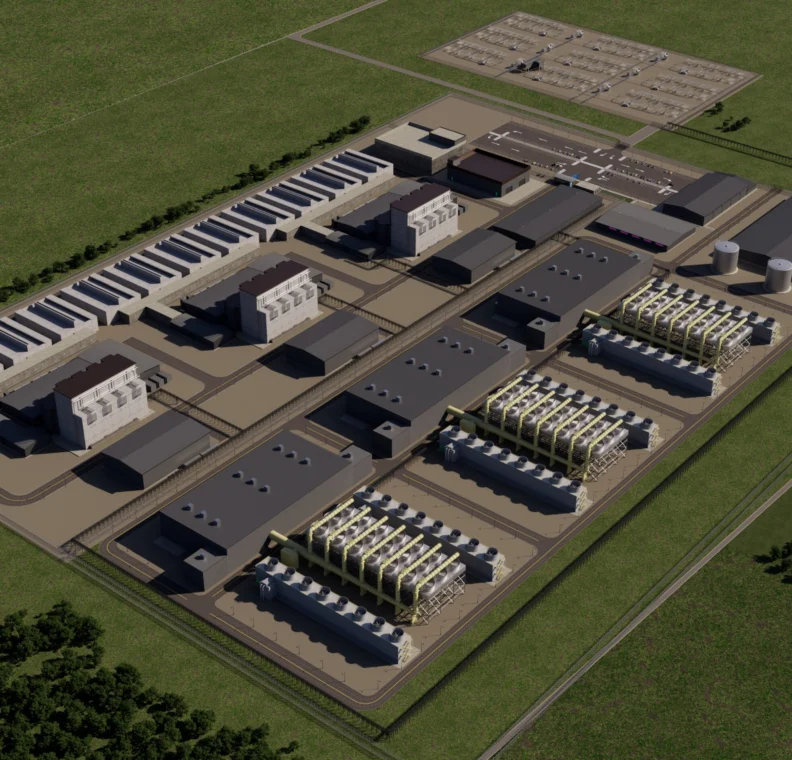 An aerial view of an industrial facility featuring several large buildings, storage tanks, and cooling units enclosed within a fenced perimeter.